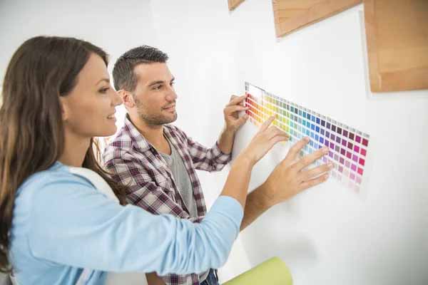 A couple choosing a color paint scheme